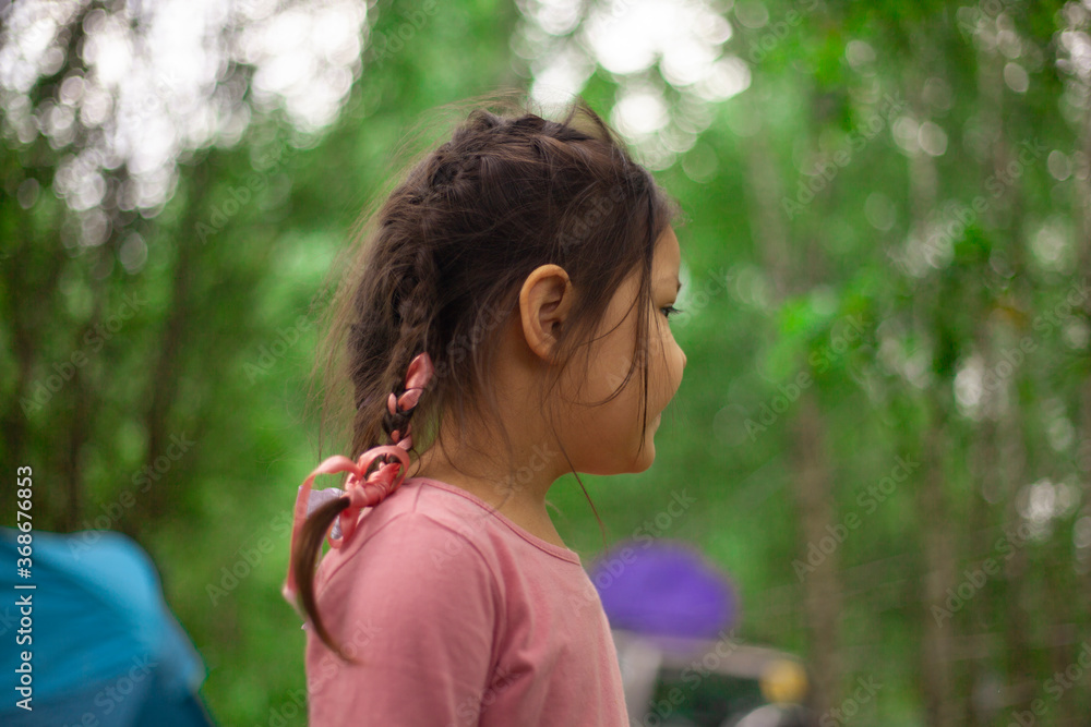 Girl 4 years old in the forest. Little girl of Asian appearance Girl 4 years old in the forest. Little girl of Asian appearance