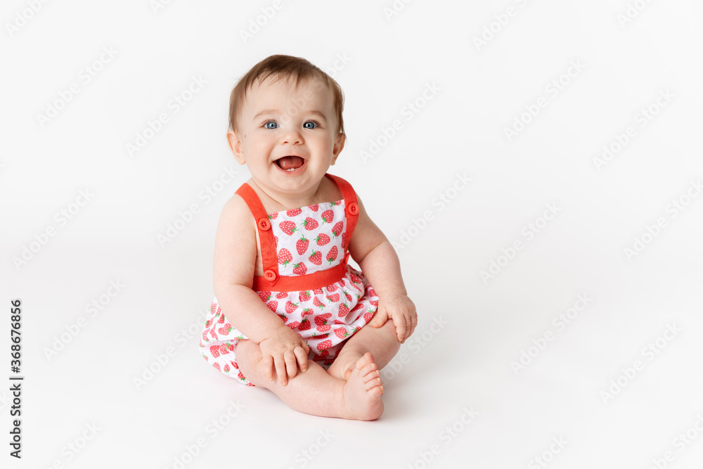 Cute smiling baby wearing strawberry outfit on white background Cute smiling baby wearing strawberry outfit on white background