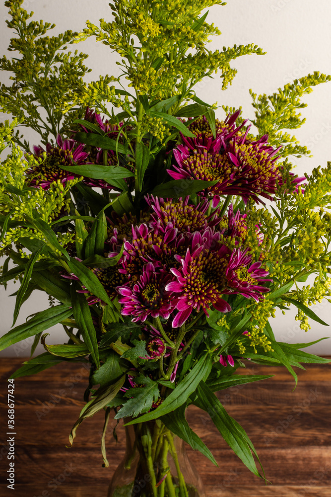 Close up of bouquet of beautiful flowers over old wood table Close up of bouquet of beautiful flowers over old wood table