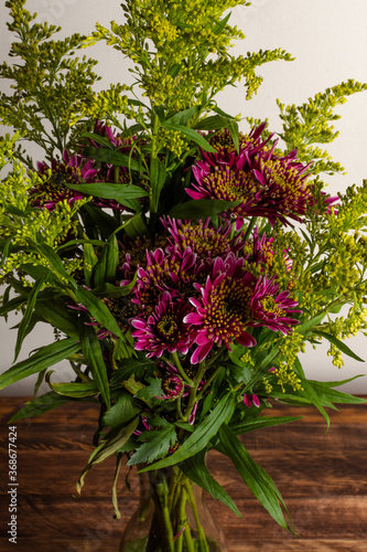 Close up of bouquet of beautiful flowers over old wood table