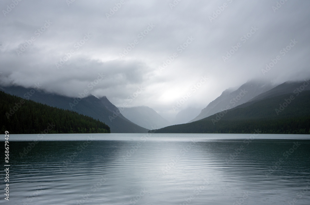Fog and clouds shroud the mountains around Bowman Lake in Glacier National Park.