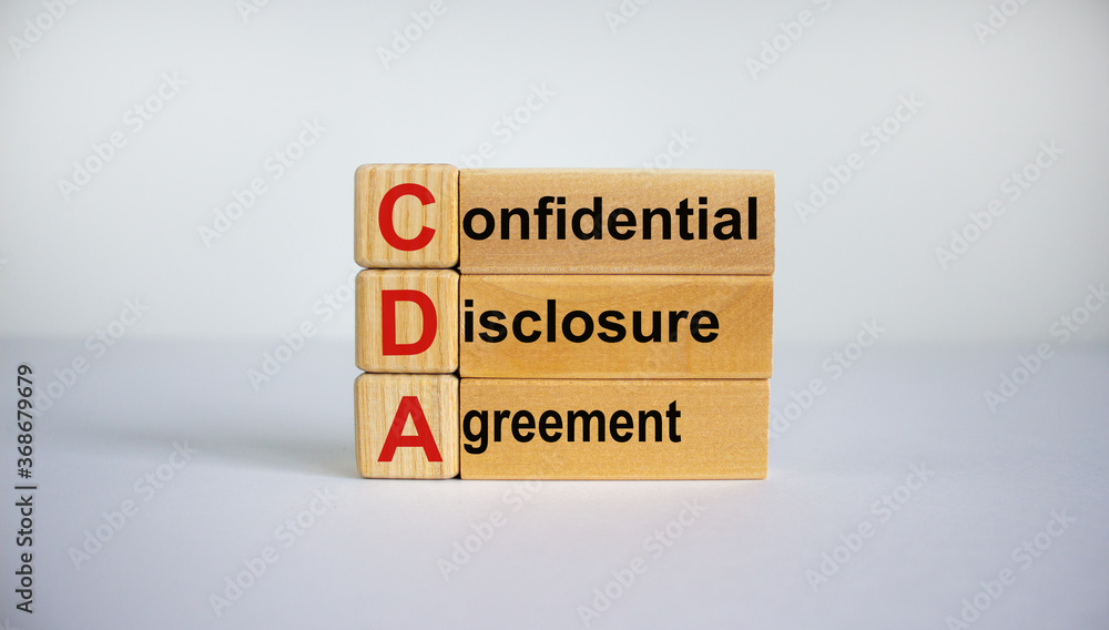 Concept words 'CDA, confidential disclosure agreement' on cubes on a beautiful blue background. Business concept, copy space. Concept words 'CDA, confidential disclosure agreement' on cubes on a beautiful blue background. Business concept, copy space.