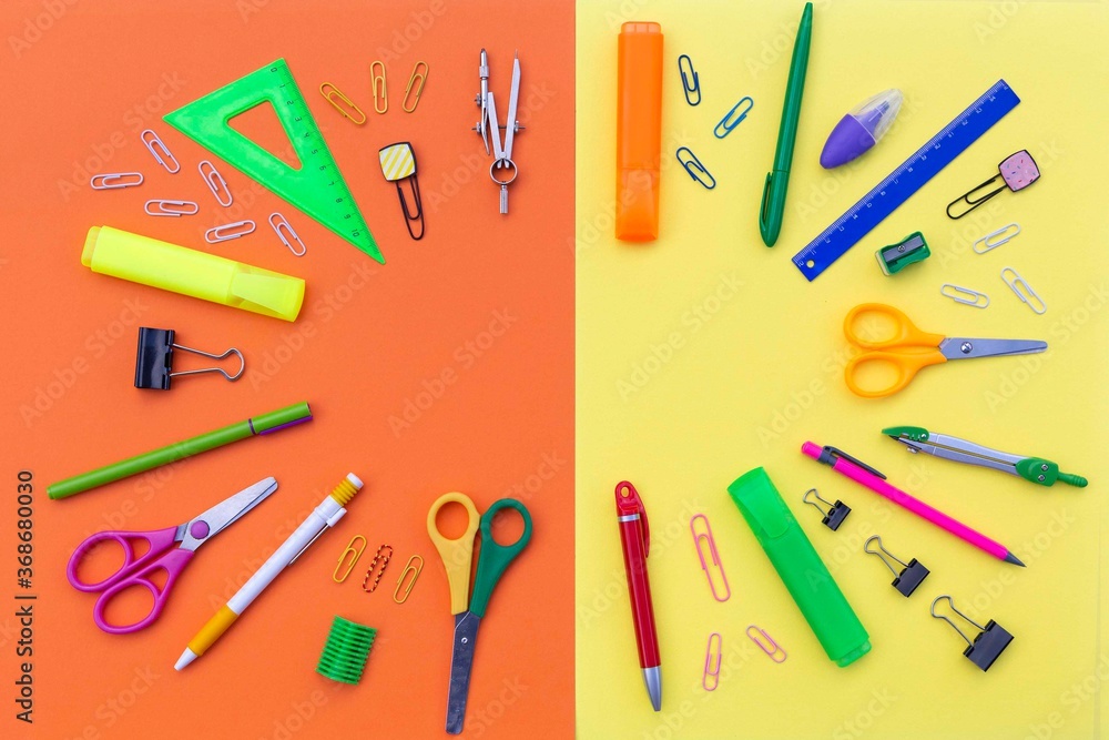 Empty copy space for your text in the frame of school supplies as pens, pencils, ruler, scissors, sharpener, marker, clips, divider. Creative flatlay with stationery on the bright background. Empty copy space for your text in the frame of school supplies as pens, pencils, ruler, scissors, sharpener, marker, clips, divider. Creative flatlay with stationery on the bright background.