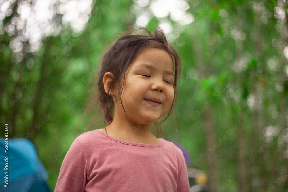 Girl 4 years old in the forest. Little girl of Asian appearance Girl 4 years old in the forest. Little girl of Asian appearance