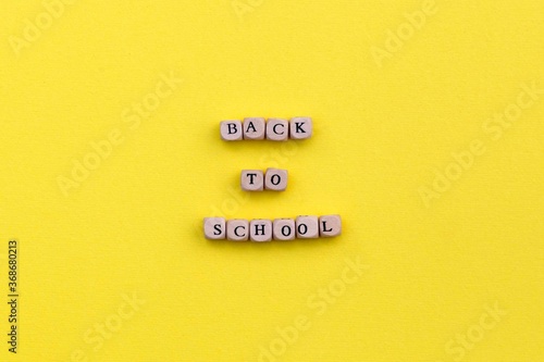 "Back to school" phrase on yellow bright background