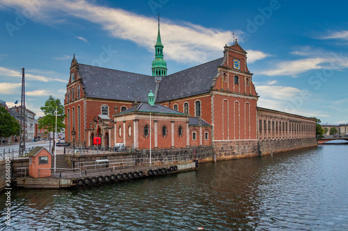 Photo of Copenhagen tourist landmark spot taken during a boat ride across the city canals, on a hot summer day with bright sky.