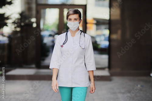 Female doctor or nurse wearing a face protective mask Covid19 healthcare concept © Maksim Selin