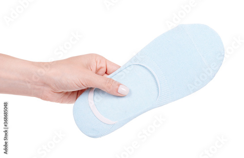 Hand with blue cotton socks, foot clothes. Isolated on white background. photo