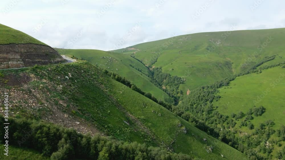 view of the green Caucasus mountains in summer from the sky with a drone in the afternoon view of the green Caucasus mountains in summer from the sky with a drone in the afternoon