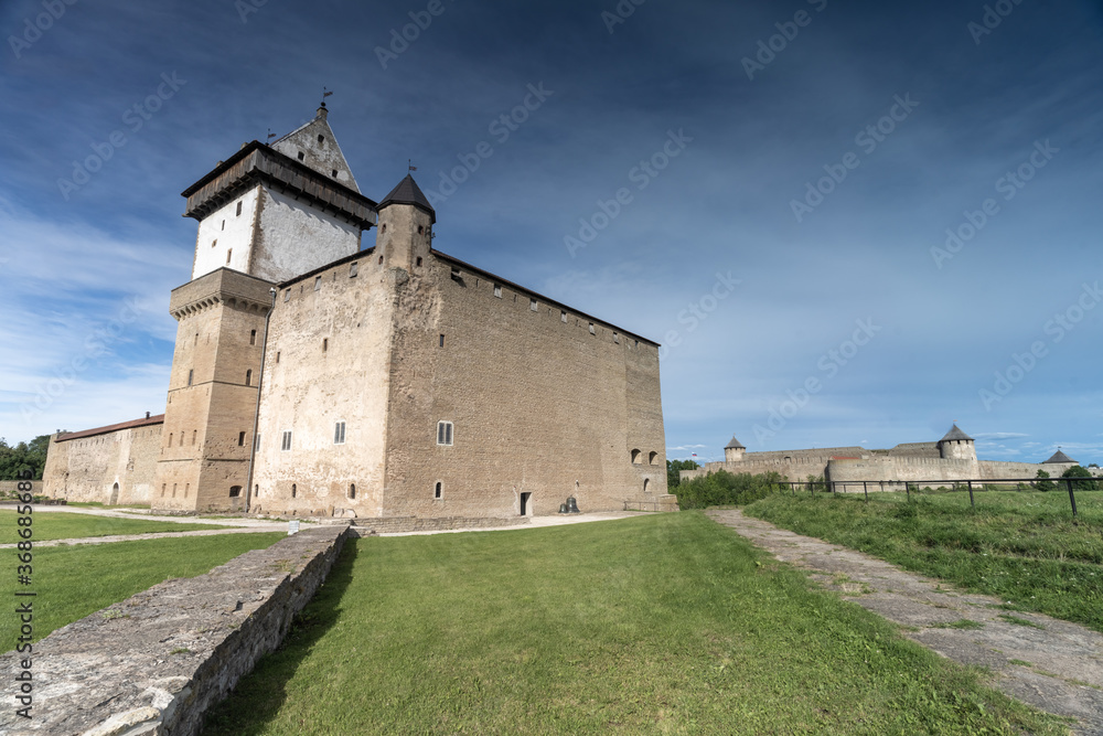 Narva, on the Narva river, at the eastern extreme point of Estonia, at the Russian border. The Narva Castle towers over the Estonian side, while Ivangorod Fortress sprawls across the Russian bank. Narva, on the Narva river, at the eastern extreme point of Estonia, at the Russian border. The Narva Castle towers over the Estonian side, while Ivangorod Fortress sprawls across the Russian bank.