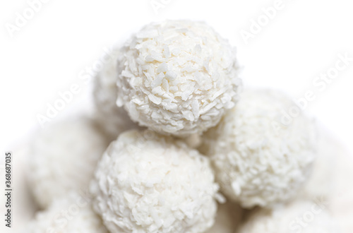 White sweet coconut truffles Closeup on white background, selective focus.