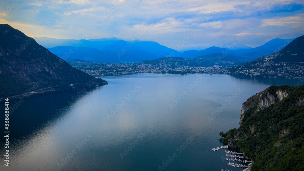 Aerial view over the Lake Lugano in Switzerland - evening view - drone footage