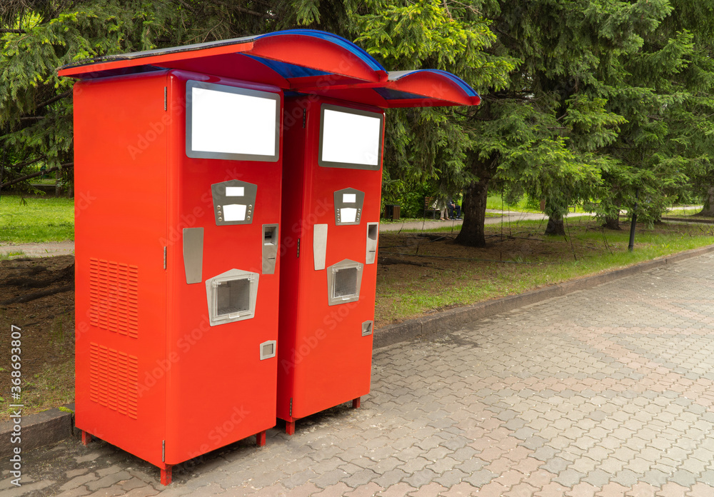 machine for drinking sparkling water installed on the street. vintage automat for making soda. Beverage vending machines selling. Red soda vending machine. copy space.