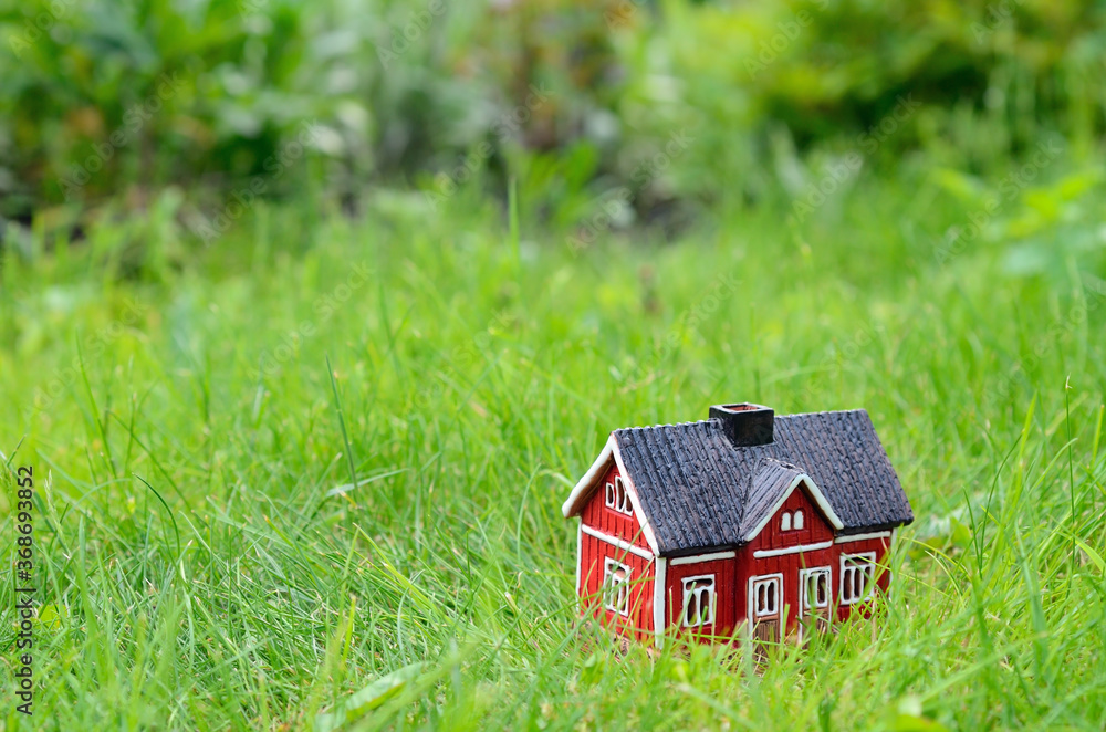 red small house model on the grass, housing concept red small house model on the grass, housing concept
