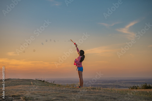 Young girl blowing bubbles
