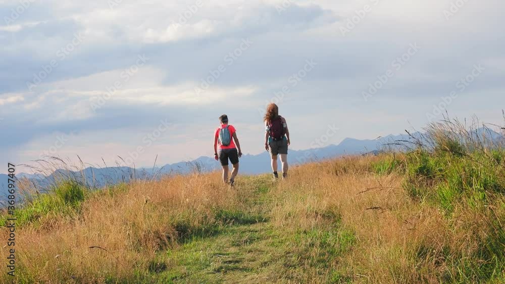 Girls having trekking walk in the alps of Lake Como Girls having trekking walk in the alps of Lake Como