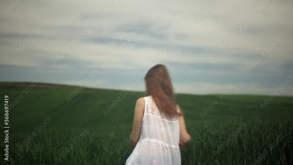 Girl putting on her mask and waking away in a field. Pollution, corona, covid 19 pandemic concept. Girl putting on her mask and waking away in a field. Pollution, corona, covid 19 pandemic concept.