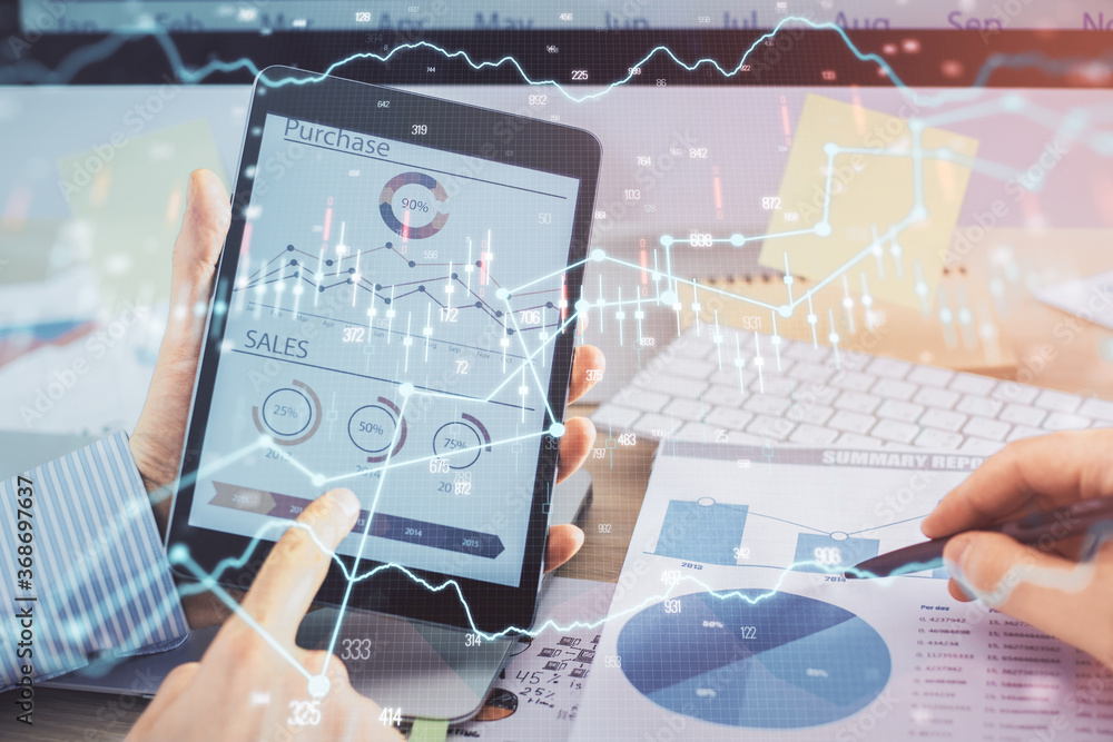 Multi exposure of man's hands holding and using a phone and financial chart drawing. Market analysis concept. Multi exposure of man's hands holding and using a phone and financial chart drawing. Market analysis concept.