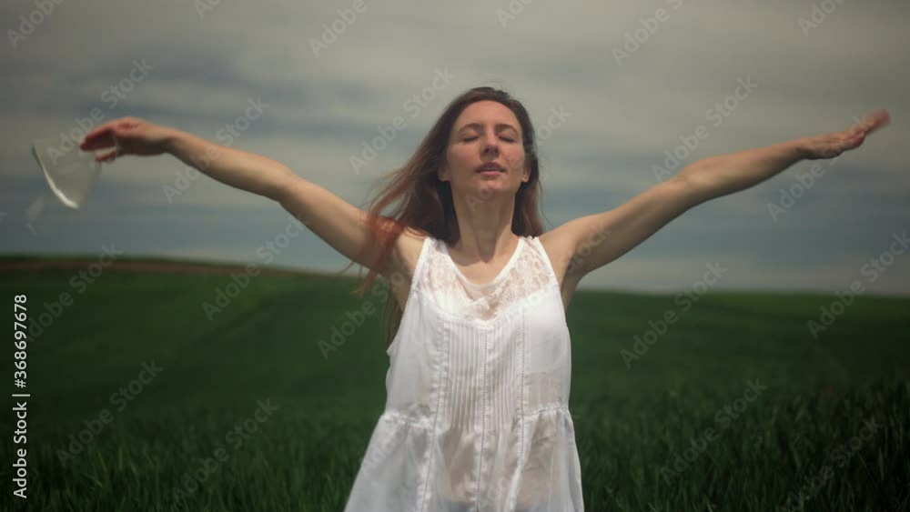 Girl taking her mask off and taking a deep breath in a field. End of corona covid 19 pandemic concept. Girl taking her mask off and taking a deep breath in a field. End of corona covid 19 pandemic concept.