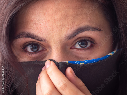 Young Attractive Brown Hair Hispanic/Latin Woman Wearing Face Mask for Cough, Flu, Virus, Viral Protection