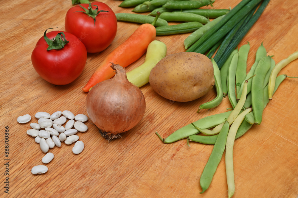 onions ,tomatoes ,paprika and green peas on table onions ,tomatoes ,paprika and green peas on table