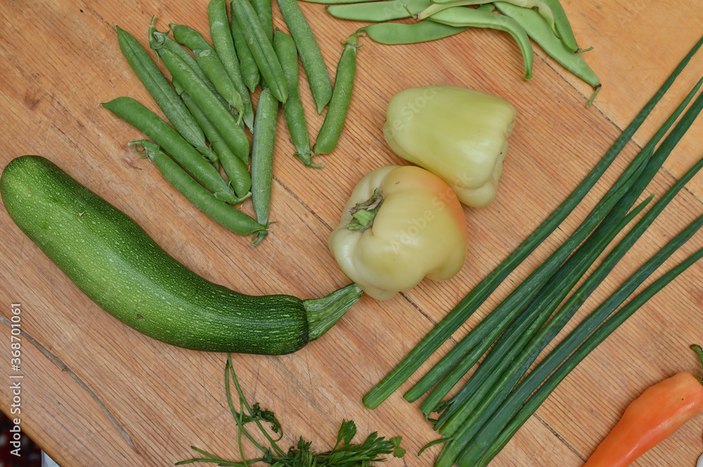 green peas, paprika,onion leafs on table green peas, paprika,onion leafs on table