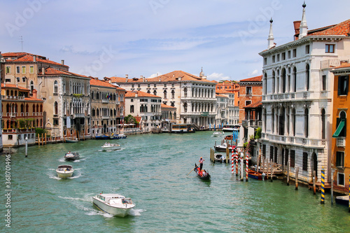 View of Grand Canal with houses and motorboats in Venice, Italy © donyanedomam