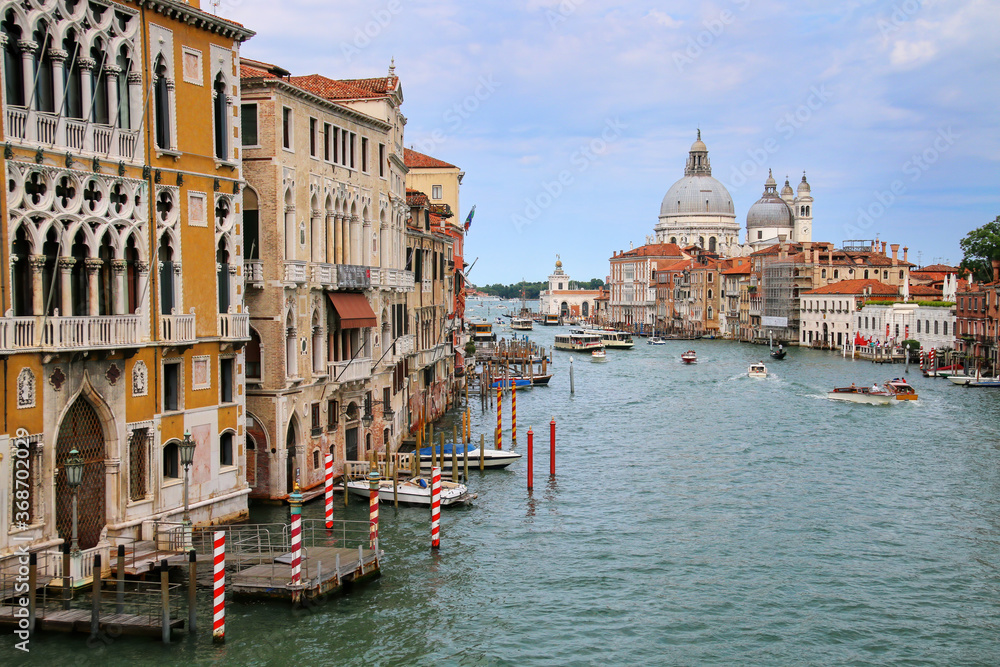 View of Grand Canal and Basilica di Santa Maria della Salute in Venice, Italy. Venice is situated across a group of 117 small islands that are separated by canals and linked by bridges.