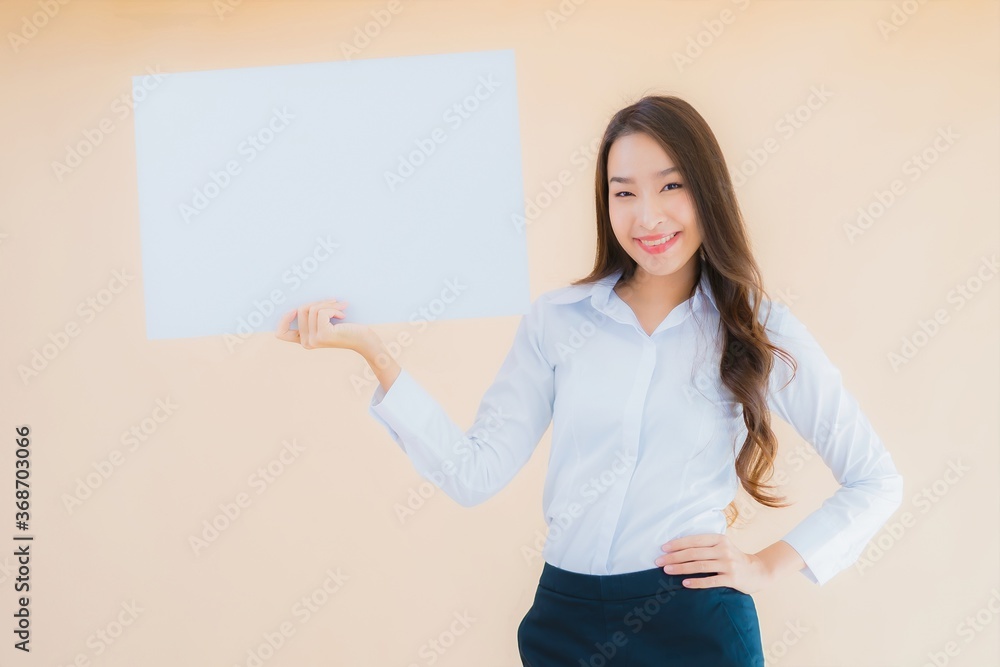 Portrait beautiful young asian business woman show white empty billboard banner Portrait beautiful young asian business woman show white empty billboard banner