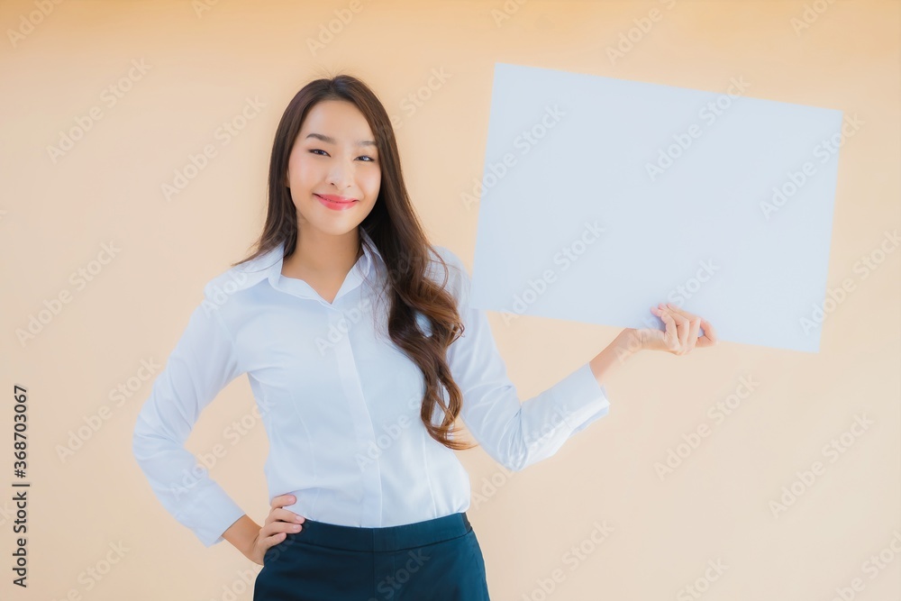 Portrait beautiful young asian business woman show white empty billboard banner Portrait beautiful young asian business woman show white empty billboard banner