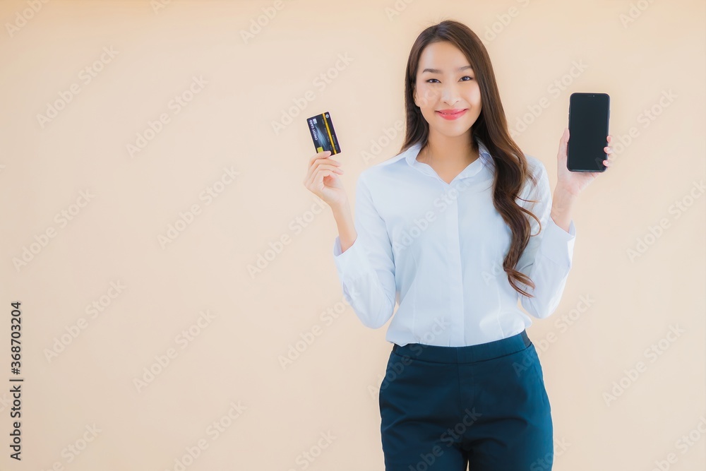 Portrait beautiful young business asian woman with phone and credit card Portrait beautiful young business asian woman with phone and credit card