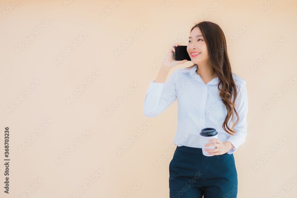 Portrait beautiful young business asian woman with smart mobile phone and coffee Portrait beautiful young business asian woman with smart mobile phone and coffee