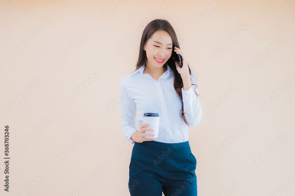 Portrait beautiful young business asian woman with smart mobile phone and coffee Portrait beautiful young business asian woman with smart mobile phone and coffee