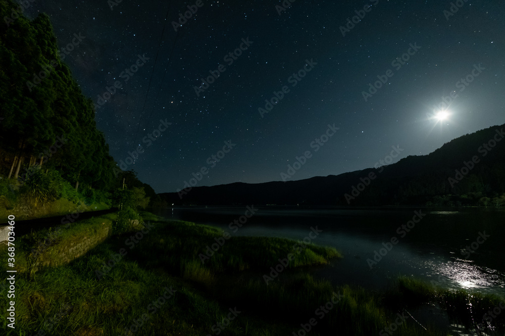 Spectacular Night sky landscape and moon, stars over the Furnas Lagoon. São Miguel Island, Azores, Portugal.