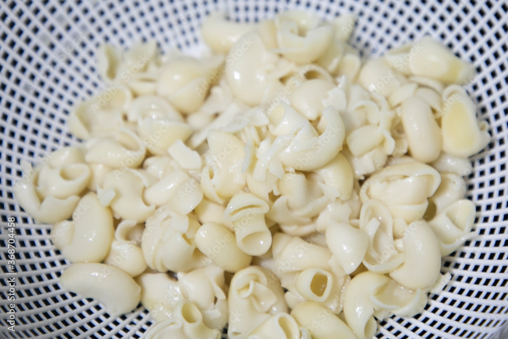 White Macroni Boiled pasta in Drained Basket White Macroni Boiled pasta in Drained Basket