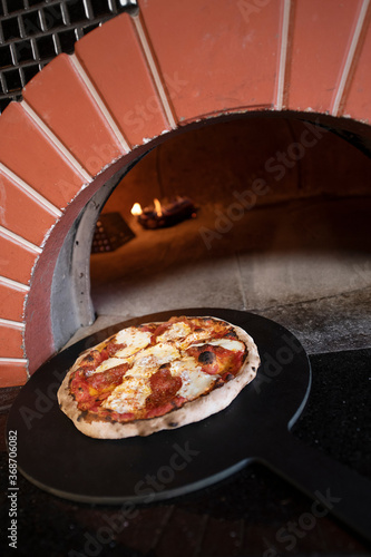 Brick Oven Pepperoni Pizza on a pizza stone 