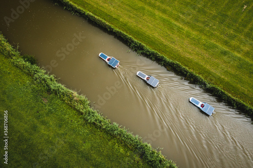 Aerial view of solar panel boats navigating through the farmlands of Schettens, Friesland, The Netherlands. photo