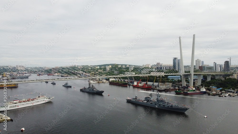 Russian naval ships under a bridge in Vladivostok
