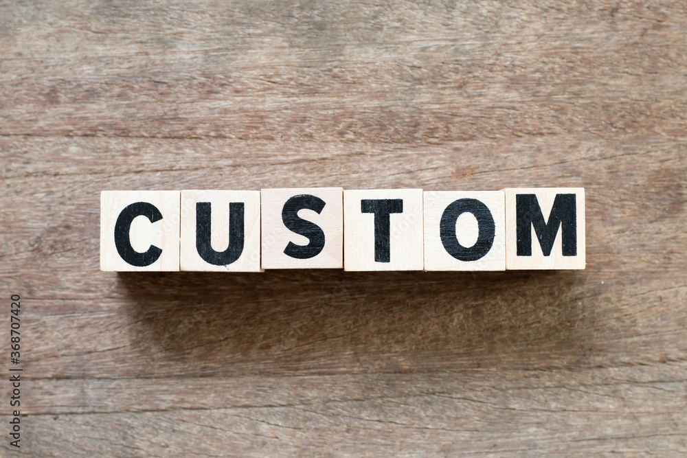 Fototapeta premium Alphabet letter block in word custom on wood background