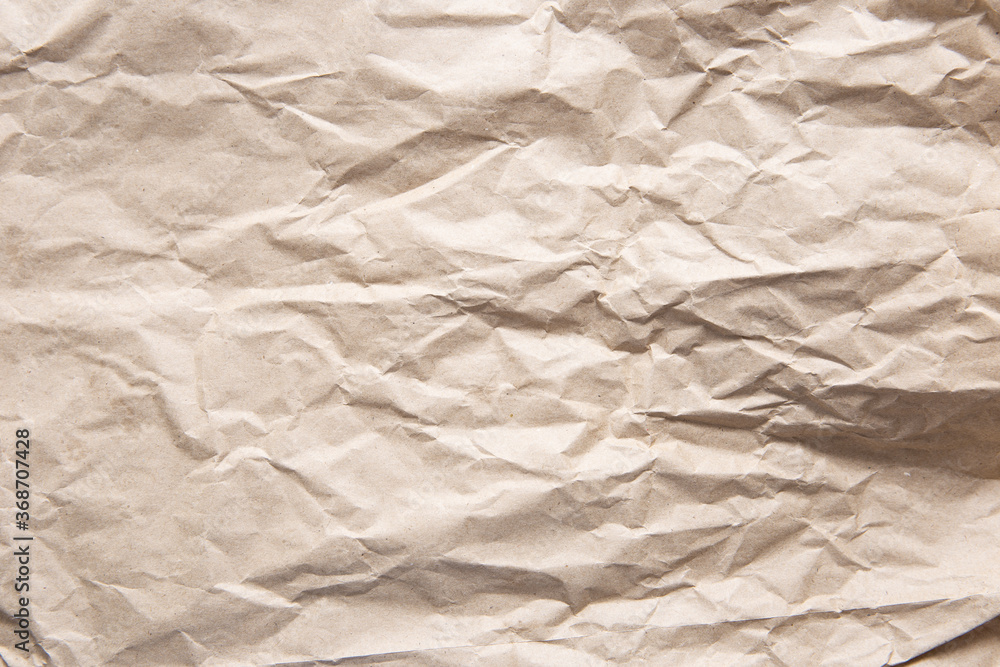 Obraz premium Crumpled old brown yellow paper. Rough old texture. Abstract background with space for text. Aging concept
