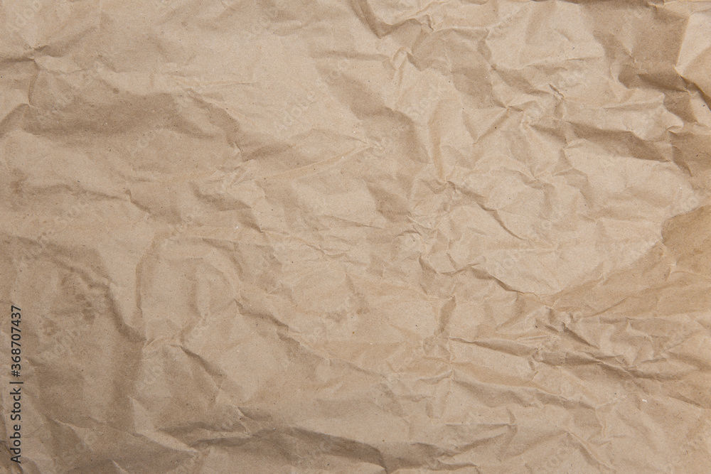 Crumpled old brown yellow paper. Rough old texture. Abstract background with space for text. Aging concept Crumpled old brown yellow paper. Rough old texture. Abstract background with space for text. Aging concept
