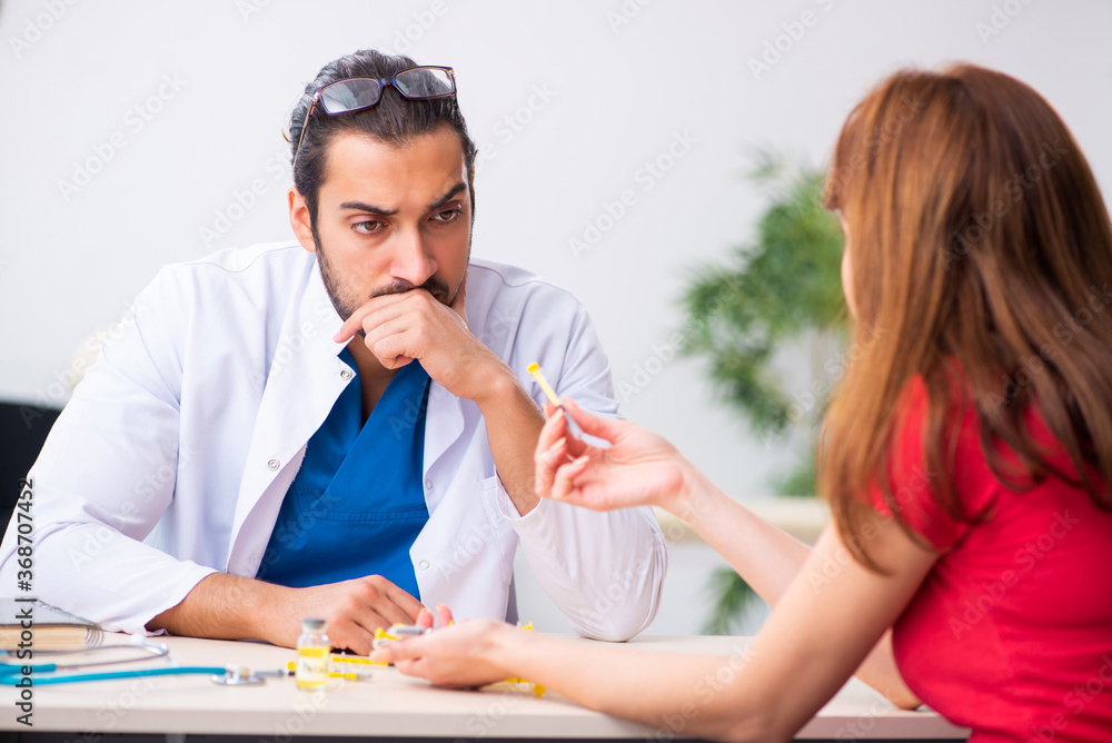 Female diabetic patient visiting young male doctor Female diabetic patient visiting young male doctor