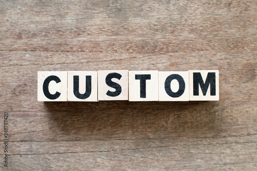 Alphabet letter block in word custom on wood background