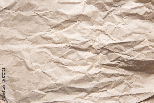 Crumpled old brown yellow paper. Rough old texture. Abstract background with space for text. Aging concept