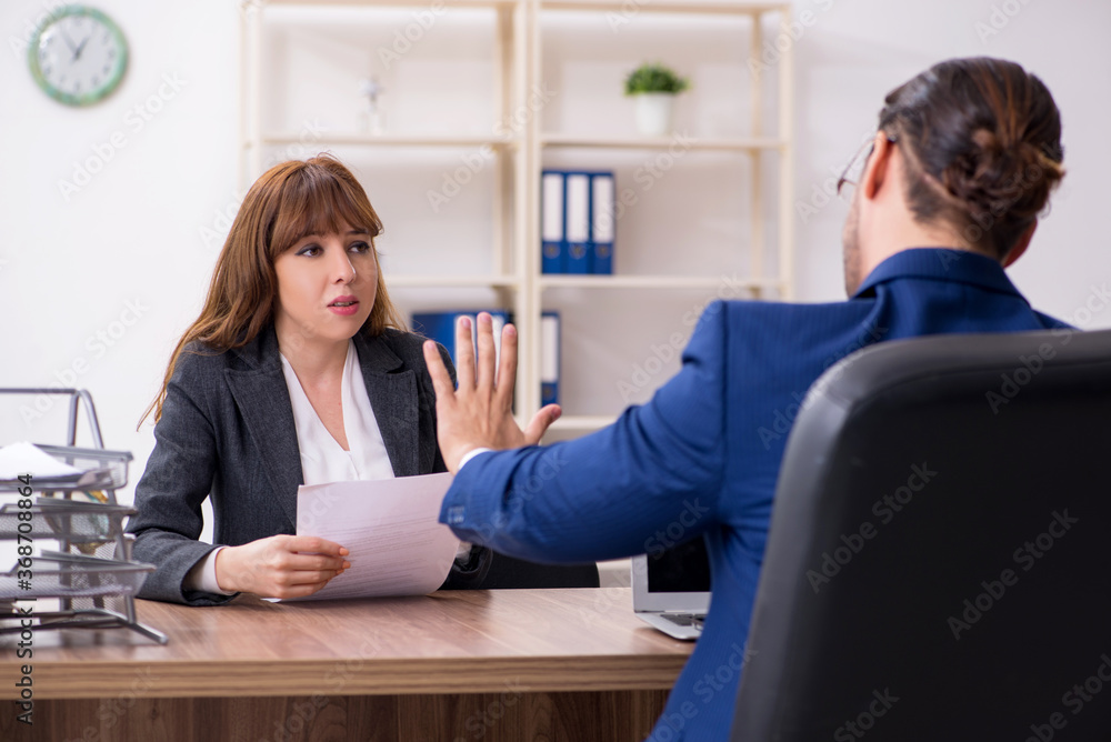 Business meeting between businessman and businesswoman Business meeting between businessman and businesswoman