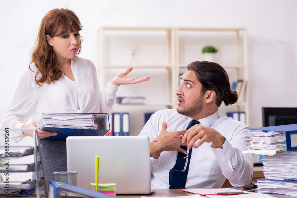 Two employees working in the office Two employees working in the office