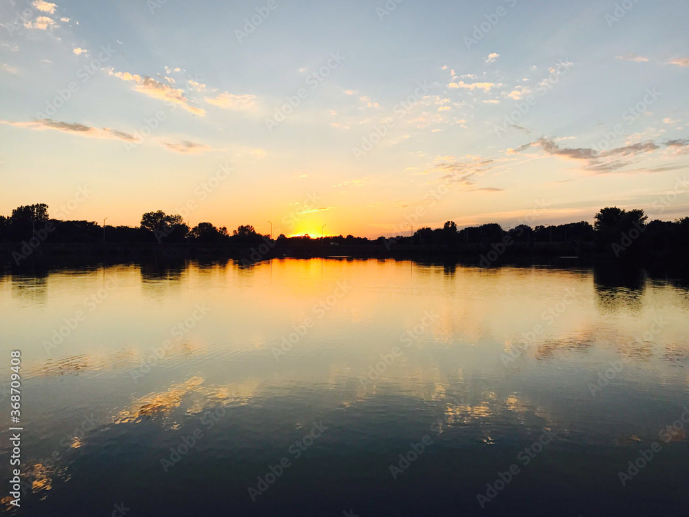 Fototapeta premium A sunset during an evening walk around a pond