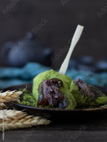 Matcha Daifuku Mochi (Green Tea Mochi With Red Bean Fillings). Green Tea Daifuku on Dark Background with Copy Space. Still life, dark food photography of Warabi Mochi. photo