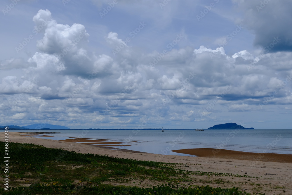 Bright beautiful seascape, sandy beach, clouds reflected in the water, natural minimalistic background and texture Bright beautiful seascape, sandy beach, clouds reflected in the water, natural minimalistic background and texture