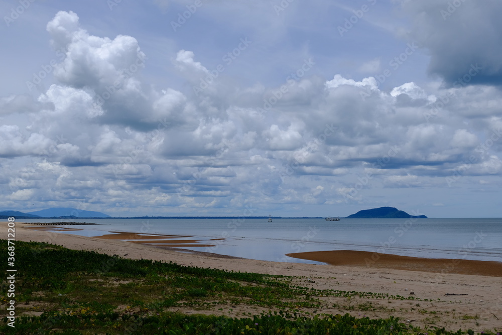 Bright beautiful seascape, sandy beach, clouds reflected in the water, natural minimalistic background and texture